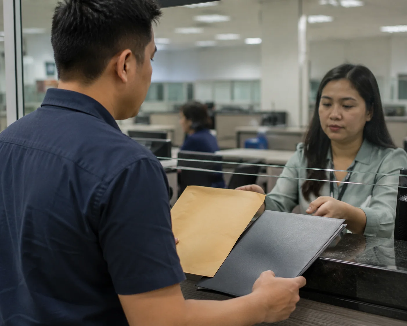 Filing paperwork over the counter at a revenue district office