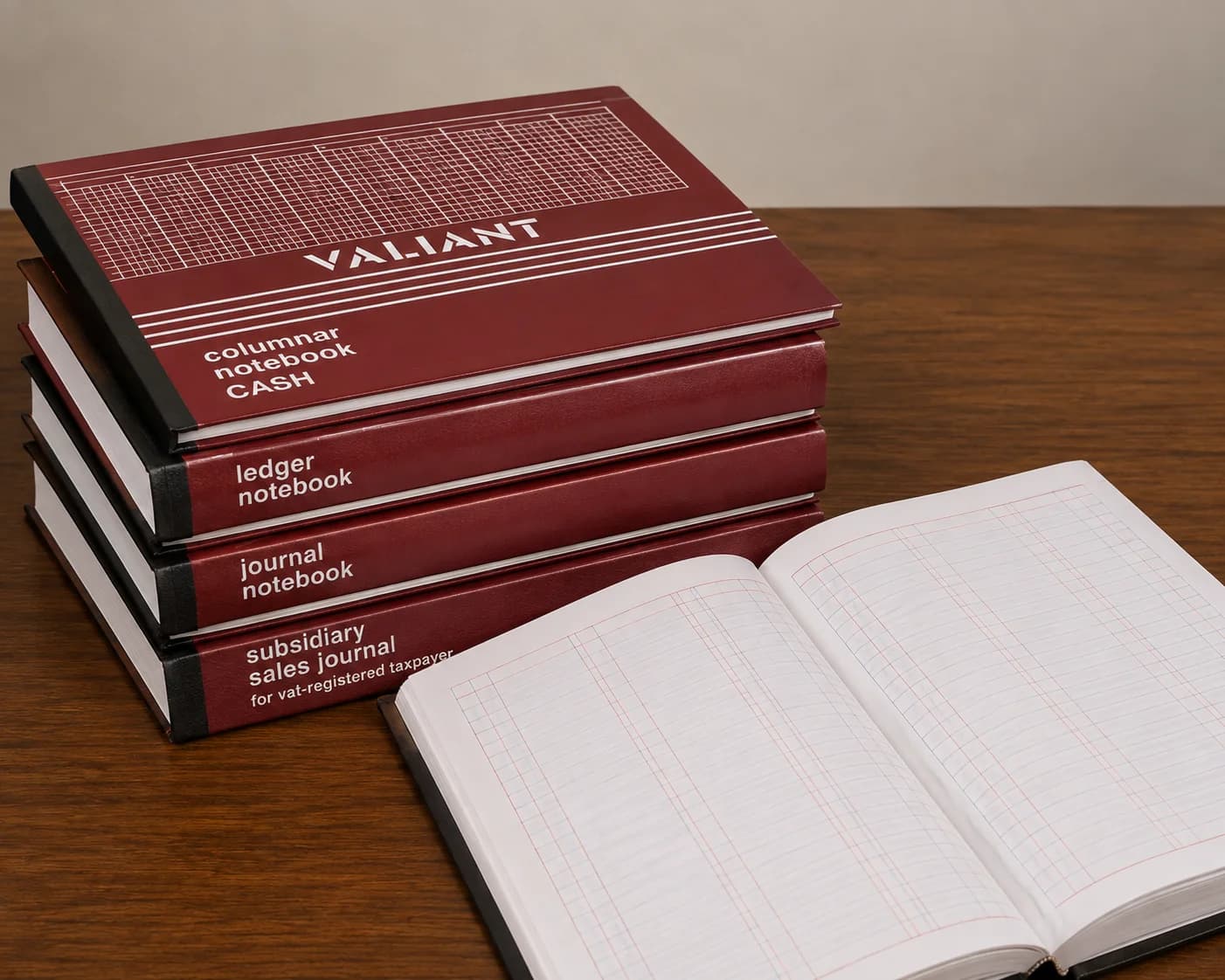 A stack of Philippine columnar books beside one open at a ruled page